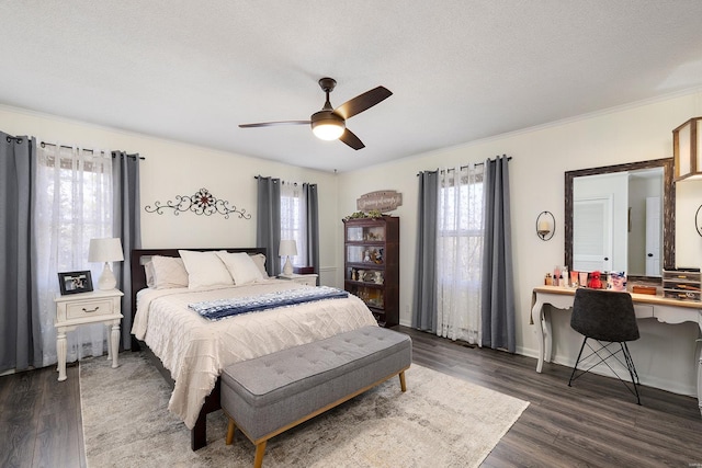 bedroom with a textured ceiling, wood finished floors, a ceiling fan, and crown molding