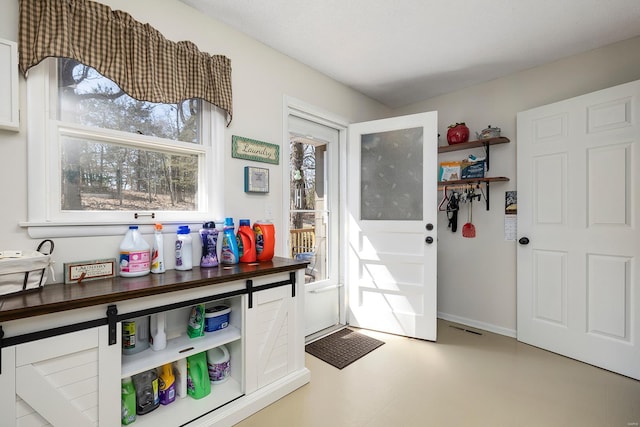 foyer entrance with visible vents and baseboards