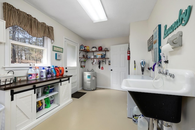 interior space featuring open shelves, electric water heater, concrete flooring, and a sink