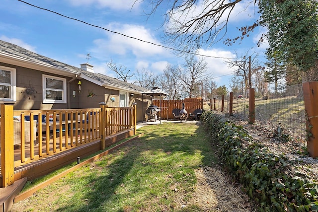 view of yard featuring a deck and fence