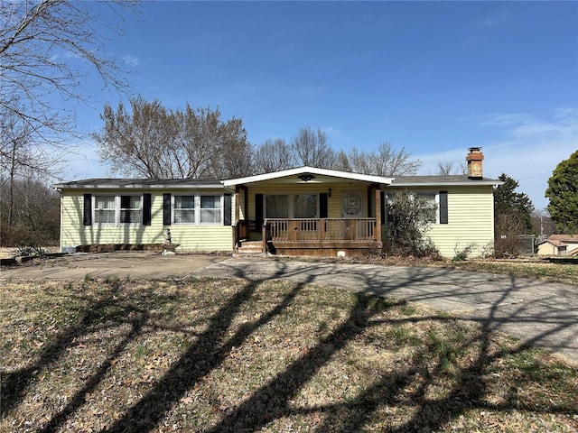 ranch-style house with covered porch and a chimney