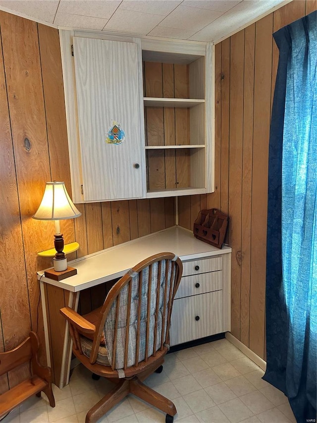 office area featuring wood walls