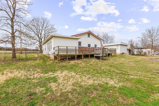 back of house featuring a deck, a yard, and fence