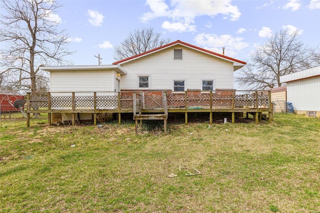 rear view of house featuring a lawn and a wooden deck