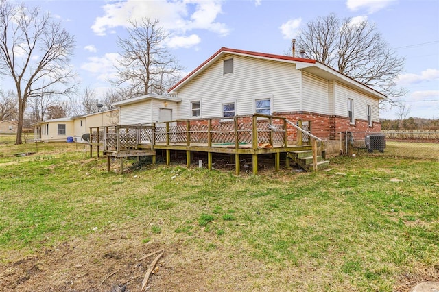 back of house featuring a deck, fence, cooling unit, a yard, and brick siding