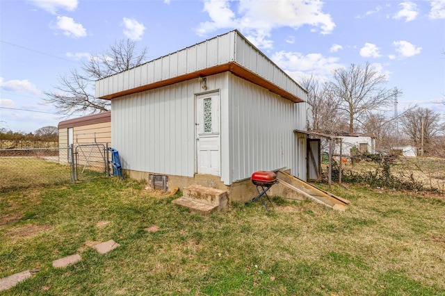 view of pole building featuring a lawn and fence