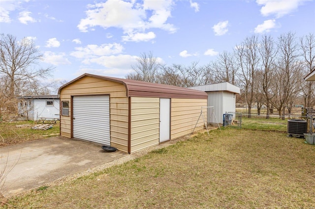 garage featuring a shed, central AC unit, and fence