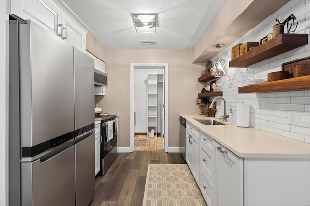 kitchen with visible vents, open shelves, a sink, appliances with stainless steel finishes, and tasteful backsplash