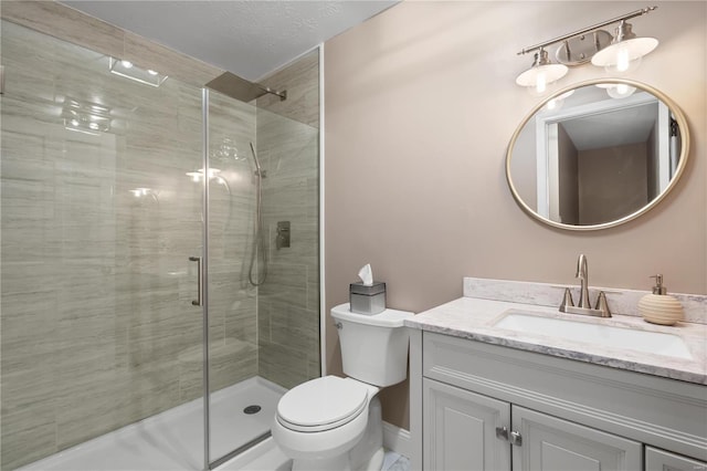 full bath featuring a stall shower, toilet, and vanity