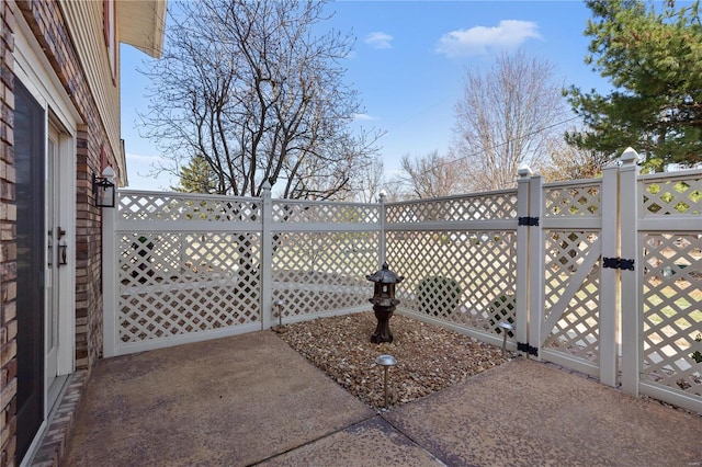 view of patio / terrace featuring fence and a gate