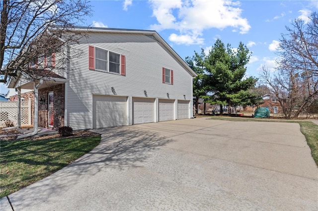 view of side of property featuring driveway and an attached garage