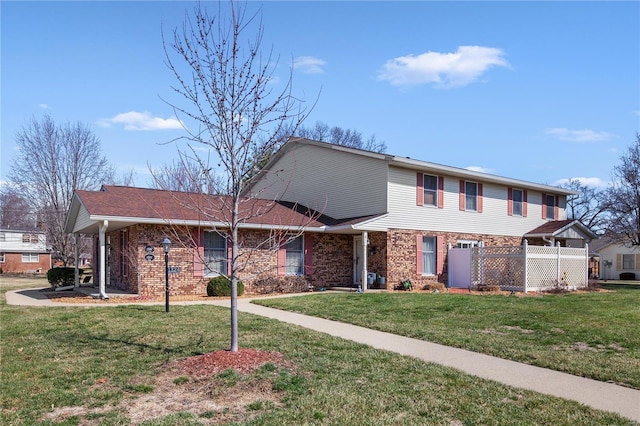 view of front of property featuring a front lawn and brick siding