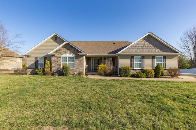 view of front facade with a front yard and stone siding