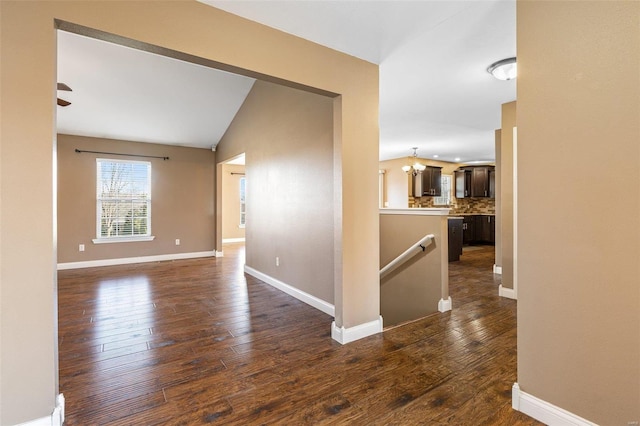 unfurnished room featuring dark wood finished floors and baseboards