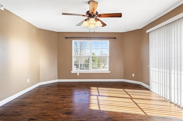 spare room featuring baseboards, a ceiling fan, and wood-type flooring