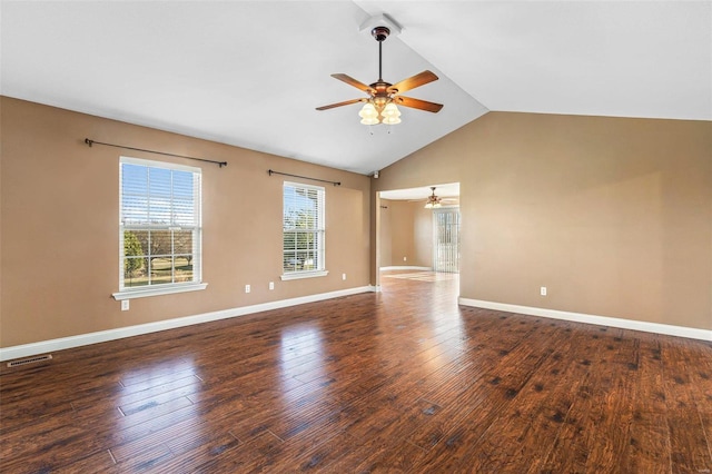 spare room featuring visible vents, hardwood / wood-style floors, baseboards, ceiling fan, and vaulted ceiling