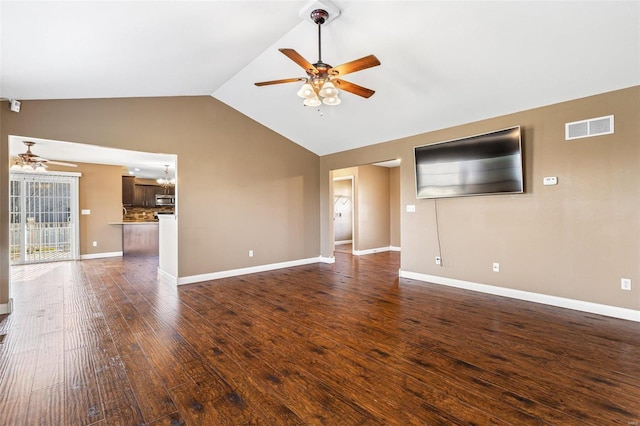 unfurnished living room with visible vents, ceiling fan with notable chandelier, dark wood-type flooring, and vaulted ceiling