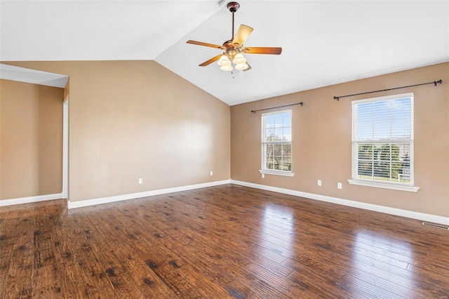 spare room featuring baseboards, visible vents, ceiling fan, hardwood / wood-style flooring, and vaulted ceiling