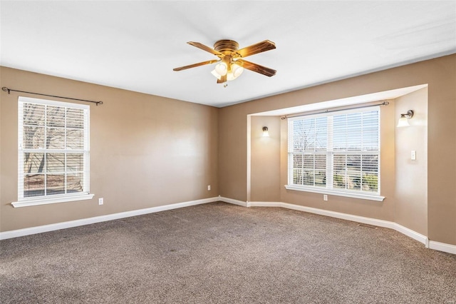 empty room featuring carpet, a ceiling fan, and baseboards