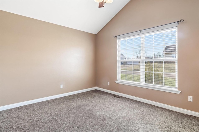 empty room with carpet, visible vents, baseboards, lofted ceiling, and ceiling fan