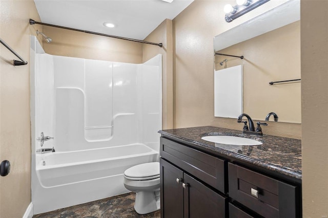 full bath with stone finish flooring, tub / shower combination, toilet, and vanity