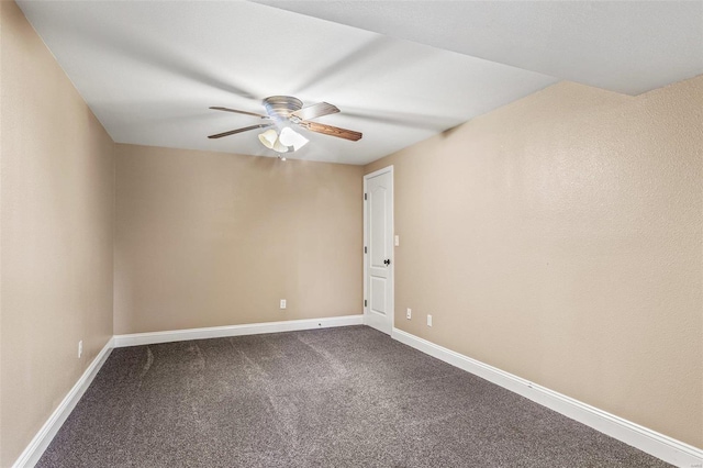 unfurnished room featuring baseboards, dark colored carpet, and ceiling fan