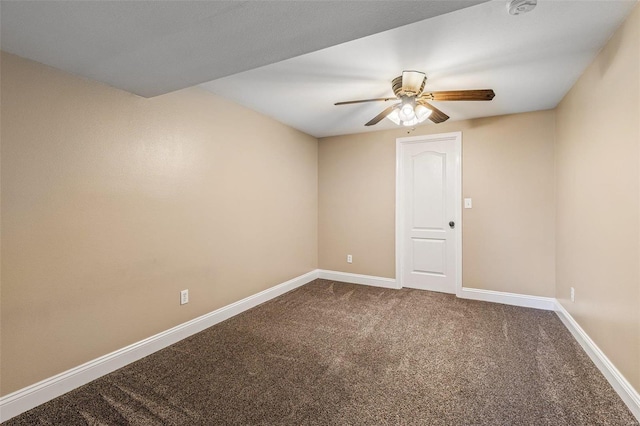 carpeted spare room with baseboards and a ceiling fan