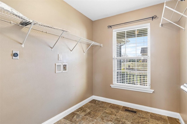 laundry room featuring visible vents, hookup for a washing machine, hookup for an electric dryer, and baseboards