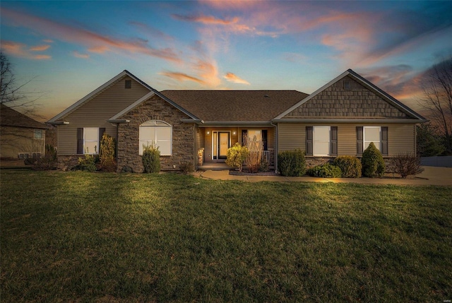 view of front facade featuring a yard and stone siding