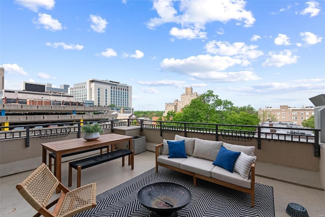 view of patio / terrace featuring a balcony, an outdoor hangout area, and a city view