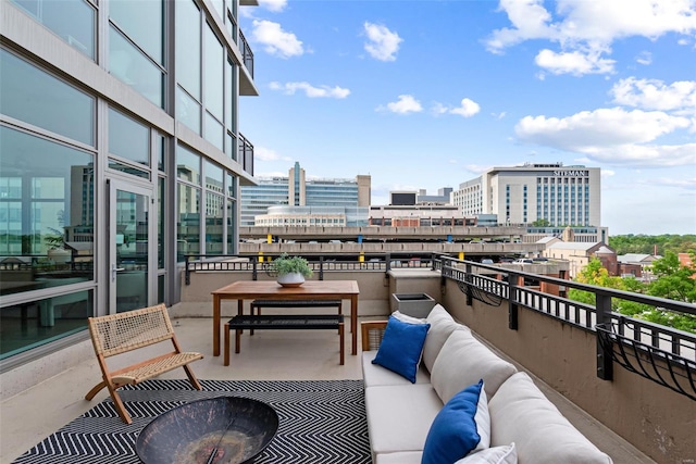 balcony featuring outdoor lounge area and a view of city