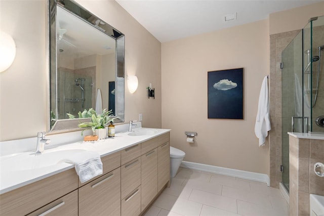 full bathroom with a shower stall, toilet, a sink, and double vanity