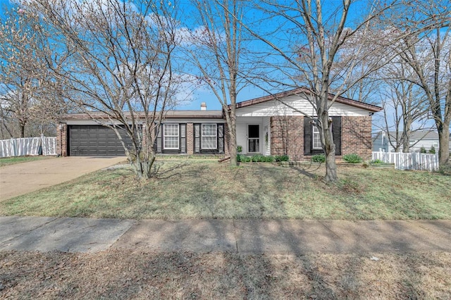 view of front of home featuring brick siding, driveway, and fence