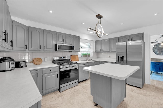 kitchen with gray cabinetry, stainless steel appliances, and light countertops