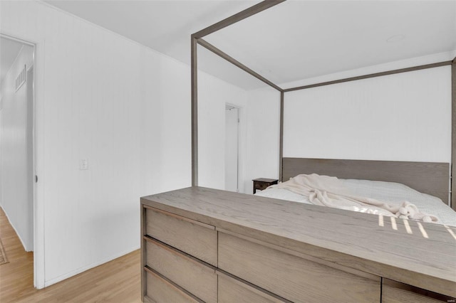 bedroom featuring light wood-type flooring and visible vents