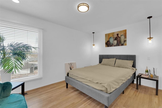 bedroom featuring baseboards and light wood-style floors