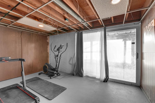 workout room featuring wood walls