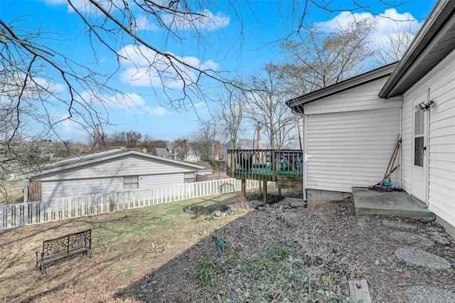 view of yard with a wooden deck and fence