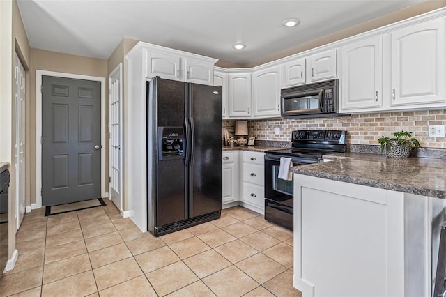 kitchen with black appliances, white cabinetry, a peninsula, light tile patterned floors, and decorative backsplash