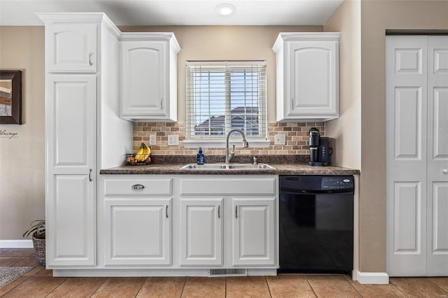 kitchen featuring dark countertops, black dishwasher, visible vents, and a sink