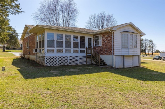 rear view of property featuring cooling unit, a lawn, brick siding, and a sunroom