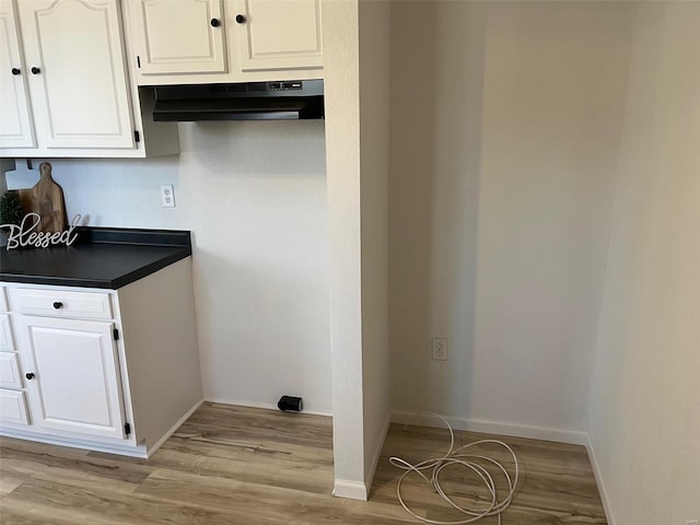 interior space featuring baseboards and light wood-type flooring