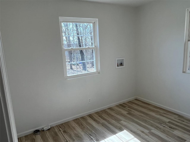 laundry room with laundry area, hookup for a washing machine, a healthy amount of sunlight, and wood finished floors