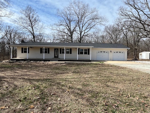 ranch-style home with an attached garage, covered porch, and driveway