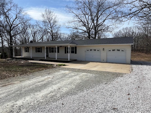 ranch-style home with a garage, covered porch, and driveway