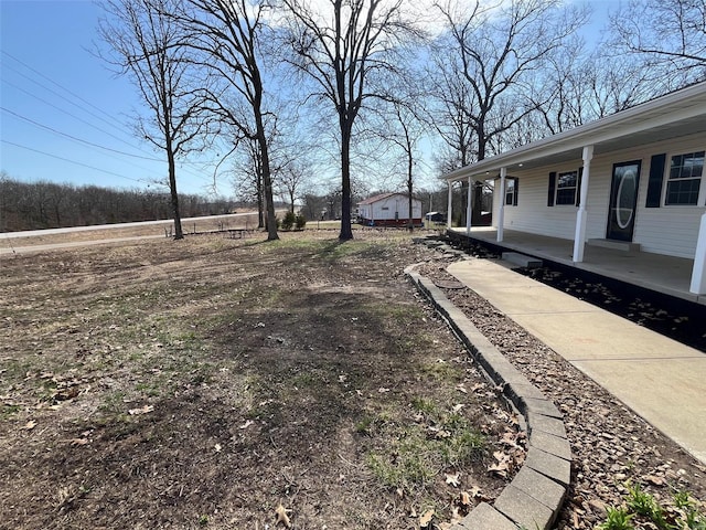 view of yard featuring covered porch