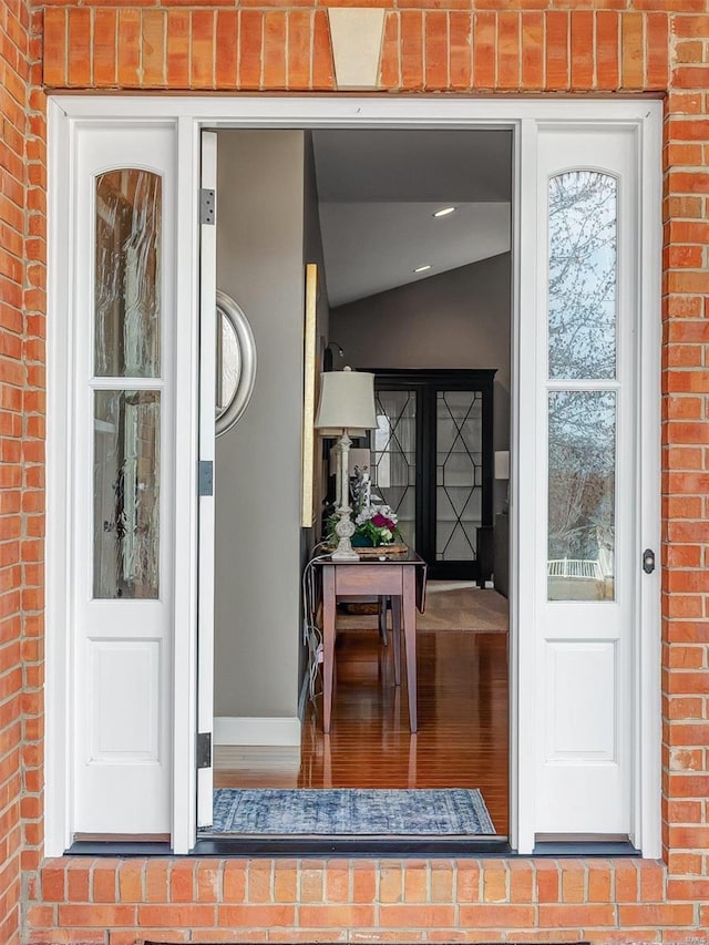 doorway to property with brick siding