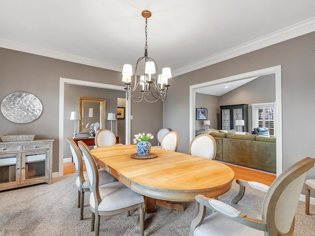 dining space featuring light carpet, baseboards, an inviting chandelier, and ornamental molding