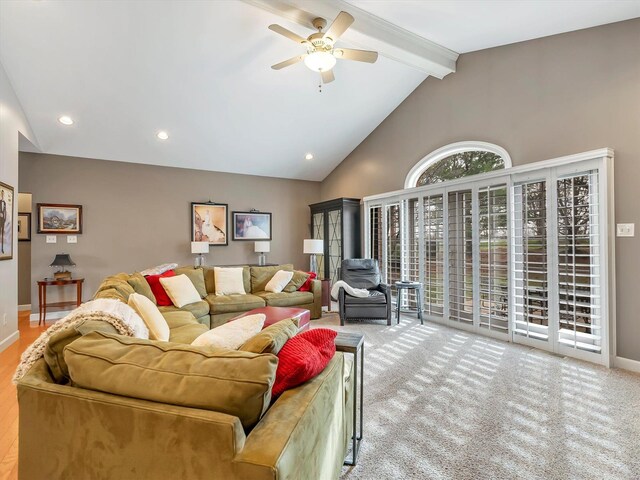 carpeted living area with baseboards, high vaulted ceiling, beam ceiling, recessed lighting, and ceiling fan