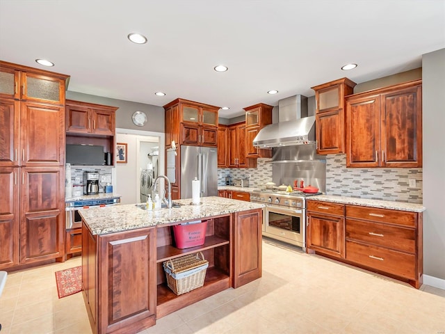 kitchen with open shelves, premium appliances, tasteful backsplash, and wall chimney exhaust hood